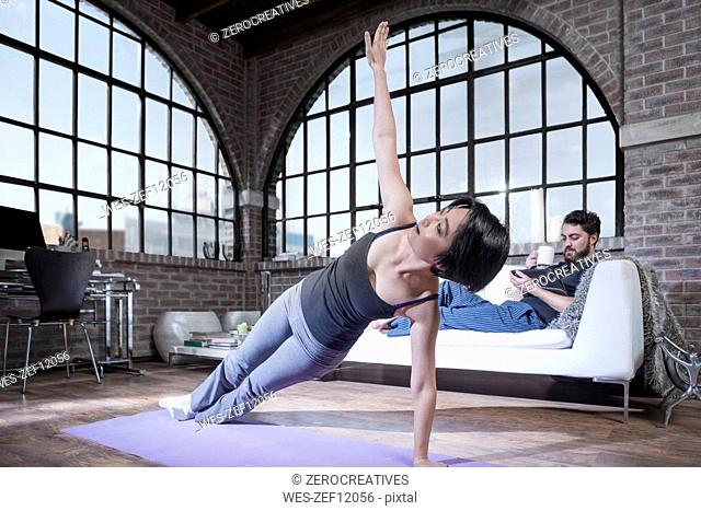 Woman doing yoga exercise in studio