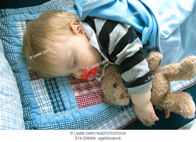 baby sleeping with teddy bear