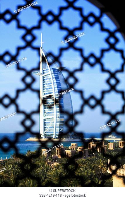 Hotel viewed through a traditional Arabian lattice window, Burj Al Arab Hotel, Jumeirah, Dubai, United Arab Emirates