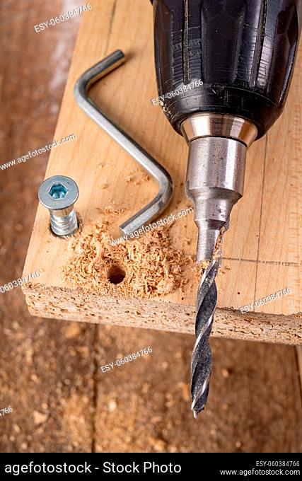 Tools and screws used in carpentry. Small carpentry work in the workshop. Light background