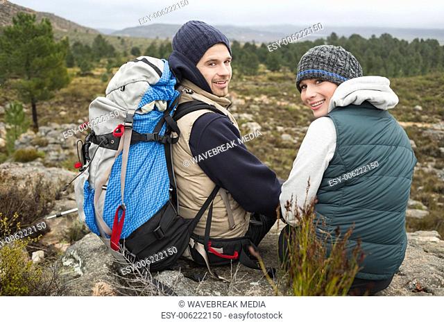 Portrait of a couple with backpack relaxing while on a hike