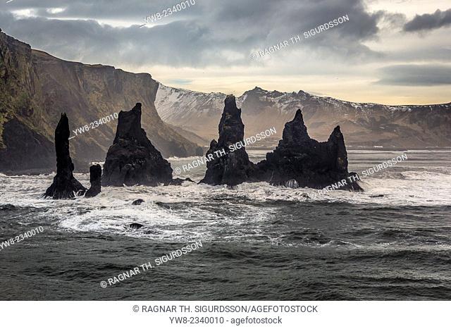 Basalt Sea Stacks and waves at Reynisfjara Beach located by Vik in Myrdal, South Coast of Iceland. Icelandic folklore states that these stacks are thought to be...
