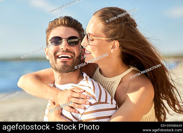 happy couple hugging on summer beach