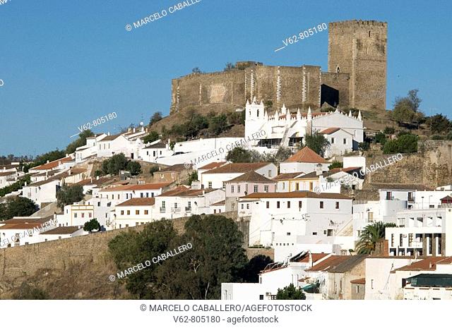 View of the old medieval city of Mértola situated in a spectacular rocky hills on the soft river Guadiana. At the top you can see a small but impressive castle...