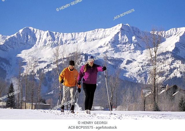 Young couple cross country skiing in Fernie, Elk Valley, East Kootenays, British Columbia, Canada