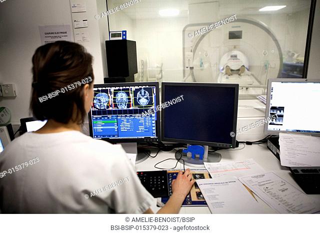 Reportage in a medical imaging service in a hospital in Savoie, France. A technician monitors a brain MRI scan session
