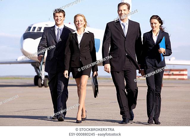 Image of business team walking through the airport