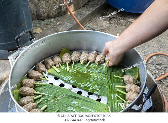Making pork satay at New Bua Tong Restaurant, 67 Sam Yaek, Wichian Buri District, Phetchabun 67130, Thailand