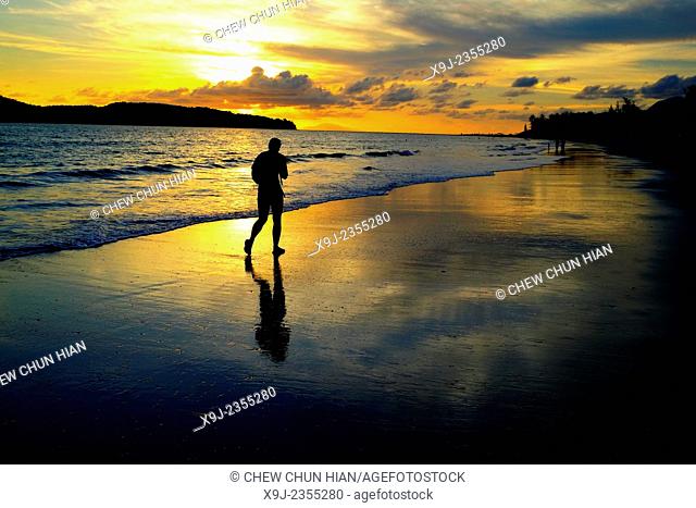 A beach at sundown with Pantai Cenang of the island Langkawi in Malaysia in southeast Asia