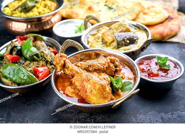 Traditional Indian Curries and Biryani with Mango Chutney and Pita Bread as top view