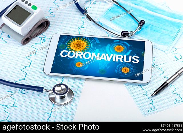 Close-up view of a tablet pc with CORONAVIRUS inscription, microbiology concept