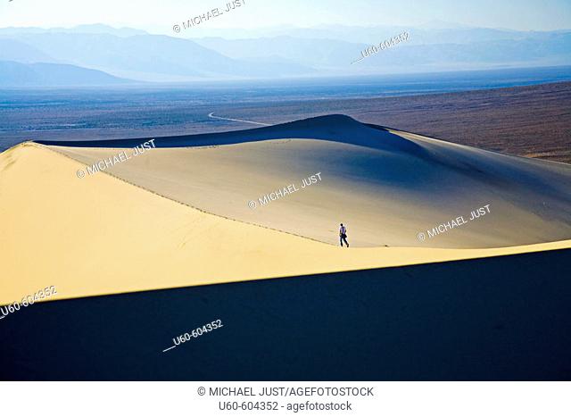 Hiker at Eureka Sand Dunes in Death Valley National Park, California. USA