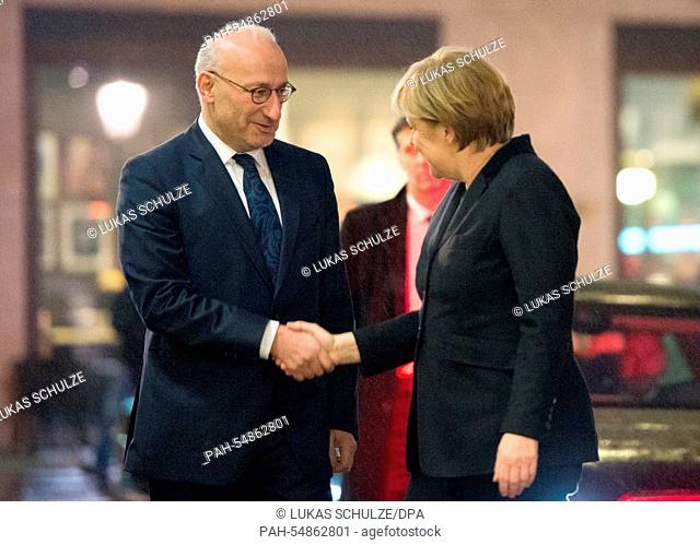 German chancellor Angela Merkel (CDU) and French Ambassador Philippe Etienne (L) shake hands at the French Embassy in Berlin, Germany, 8 January 2015