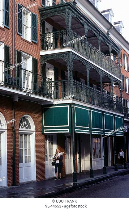 Woman standing in front of house, French Quarter, Bourbon Street, New Orleans, Louisiana, USA