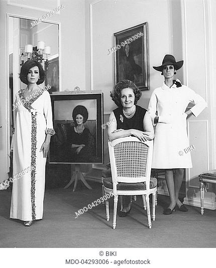 Italian fashion designer Biki (Elvira Leonardi Bouyeure) in the fashion show room at her atelier with two models. Beside her her son-in-law Alain Renaud