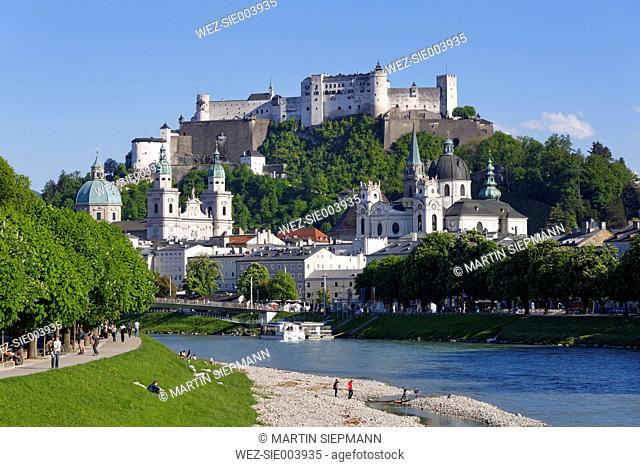 Austria, Salzburg, View of Collegiate Church and Hohensalzburg Castle at River Salzach