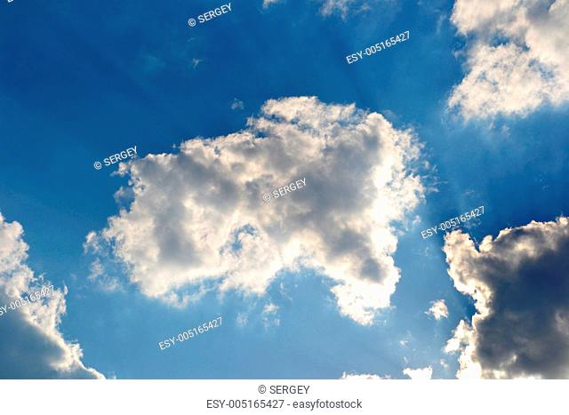 Blue sky with clouds and rays of sun