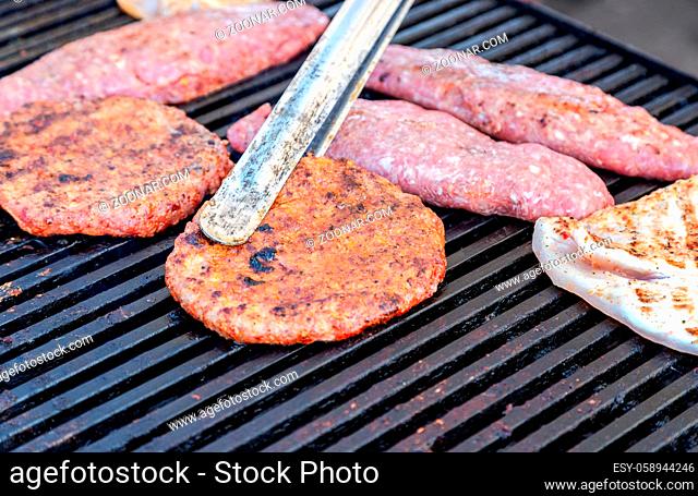 Appetizing pieces of grilled meat cooked on the grill over the hot coals