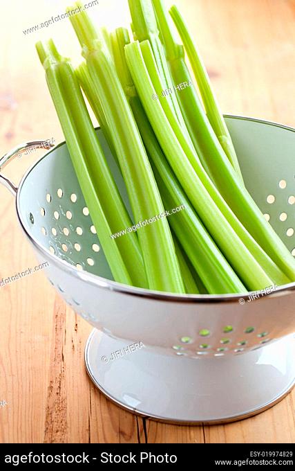 green celery sticks in colander