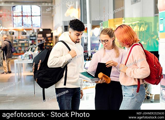 Young friends in library