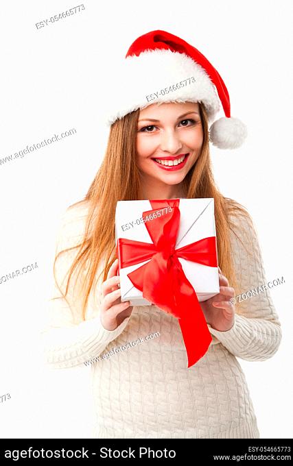 Christmas Santa hat isolated. Woman hold christmas gift. Smiling happy girl on white background