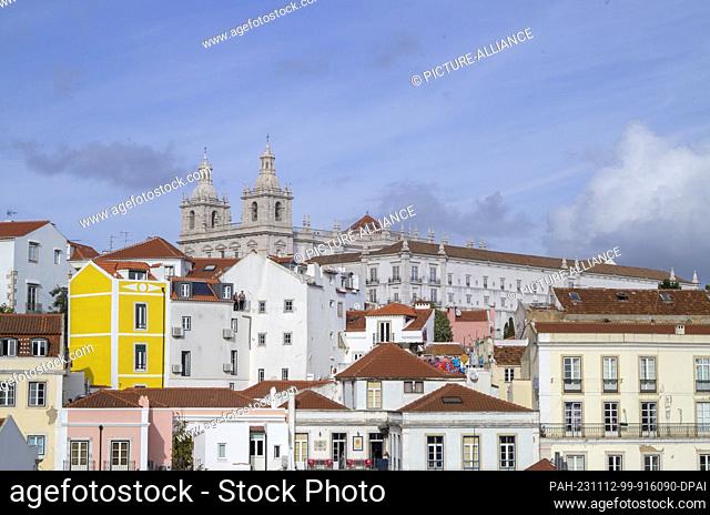 PRODUCTION - 27 October 2023, Portugal, Lissabon: Behind the houses of the Alfama district, the monastery of Sao Vicente de Fora stands out on a hill