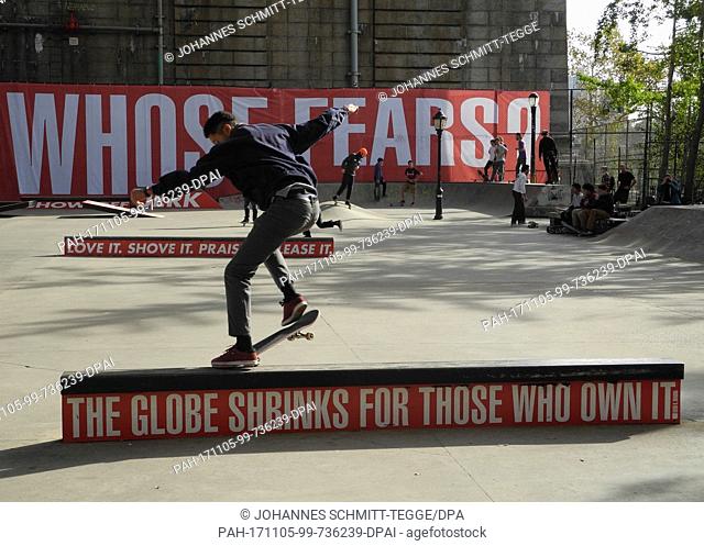 Skaters skate in a skatepark over ramps of a parcour adorned with edgy statements by American artist Barbara Kruger in New York, USA, 04 November 2017