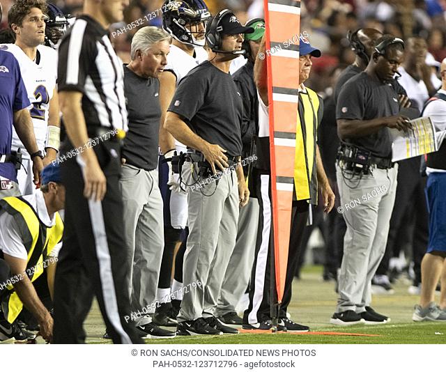 Baltimore Ravens head coach John Harbaugh, center, watches second quarter action against the Washington Redskins at FedEx Field in Landover