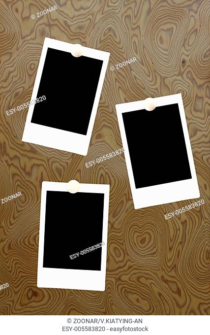 blank polaroids frames on a wood background