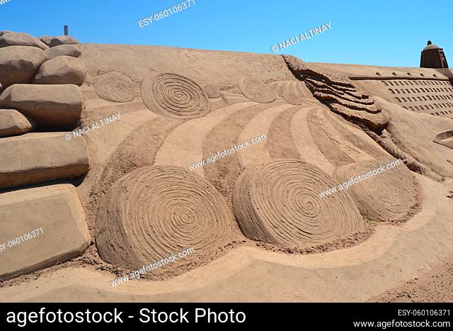 Sand sculpture depicting hay bales after the wheat harvest