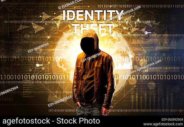 Faceless hacker at work with IDENTITY THEFT inscription, Computer security concept