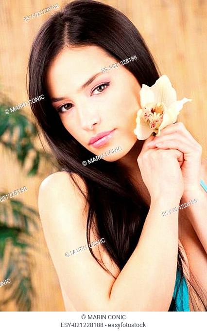 woman holding white orchid