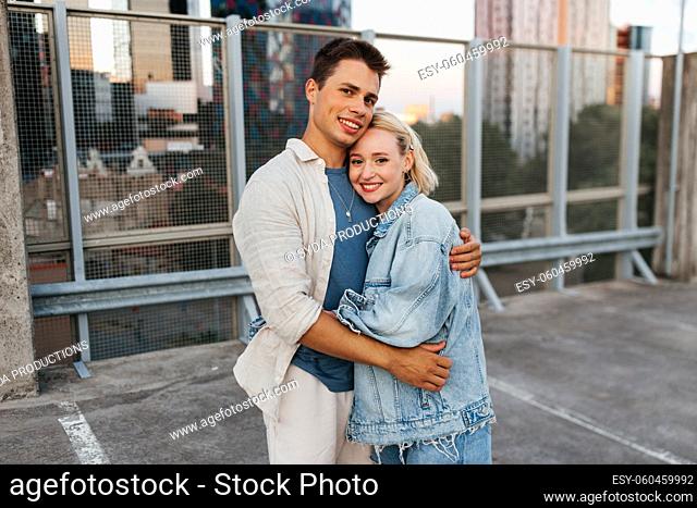 happy couple hugging on roof top city parking