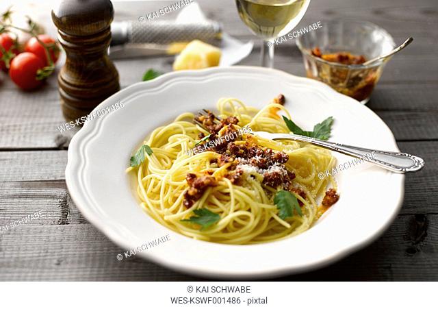 Dish of spaghetti with tomato pesto and grated parmesan