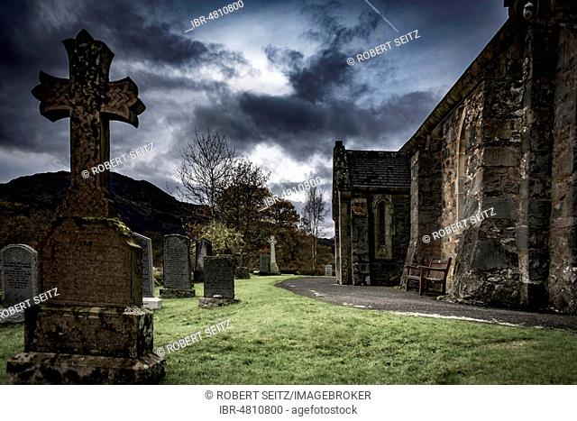 Church St. John with cemetery under dramatic sky, Ballachulish, Glen Coe, west Highlands, Scotland, United Kingdom