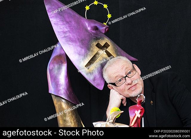Czech sculptor Vaclav Cesak poses with one of three statuettes of St John of Nepomuk, down center, on February 8, 2020, in Novy Smolivec, Czech Republic