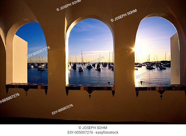 This is the view of Avalon overlooking the Harbor on Via Casino. It shows morning on Catalina Island looking out an arched window