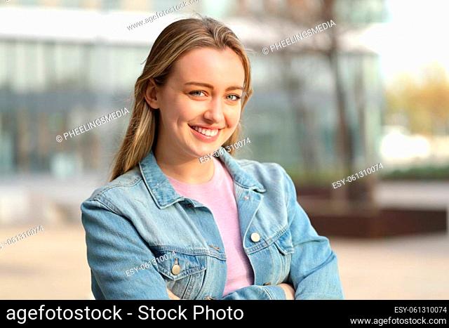Happy teen posing looking at camera standing in the street