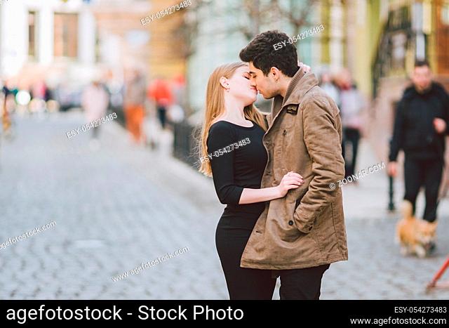 Urban modern young love couple walking romantic talking talking, holding hands on a date. Young multicultural Turkish brunette and Caucasian couple on old...