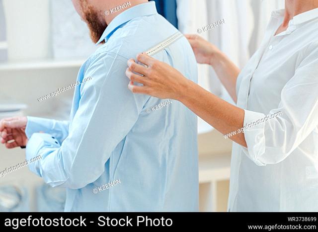 Man in fitting of a bespoke shirt in fashion studio of tailor
