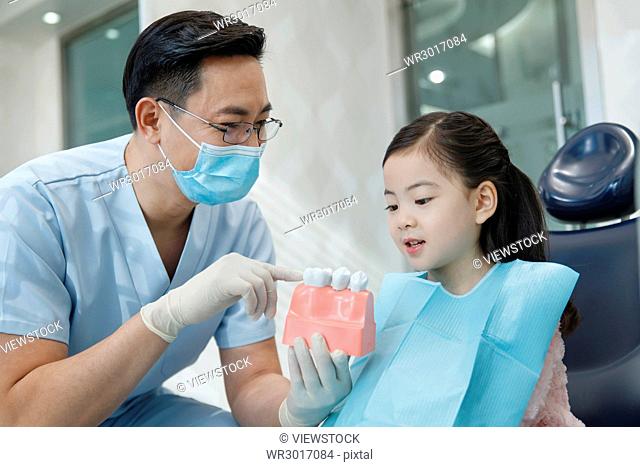 Cute little girl and dentist