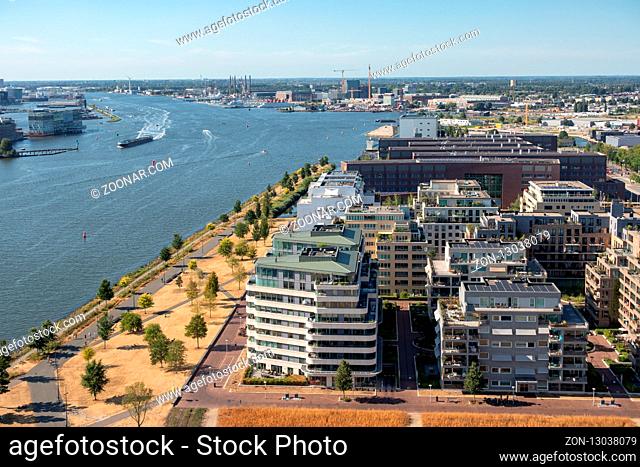 Aerial view apartment buildings Amsterdam near harbor and North Sea canal