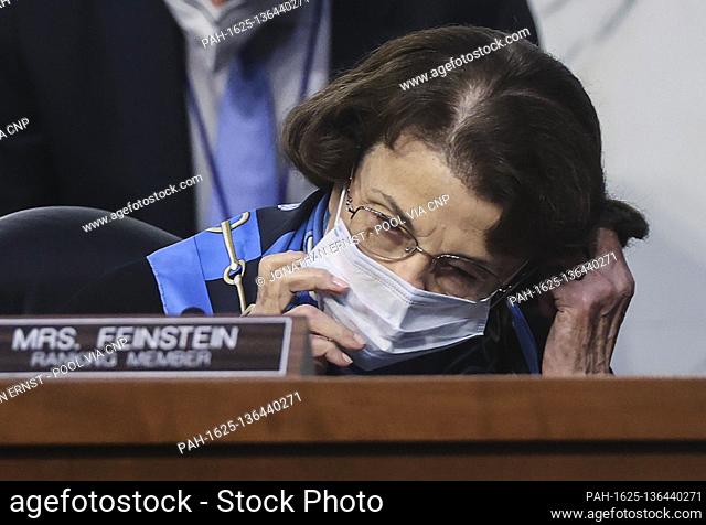 United States Senator Dianne Feinstein (Democrat of California), Ranking Member, US Senate Judiciary Committee adjusts her face mask as she attends the third...
