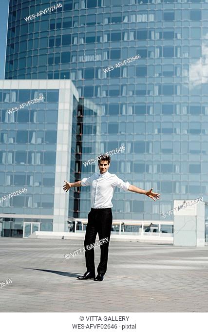 Spain, Barcelona, portrait of smart man standing on roof terrace