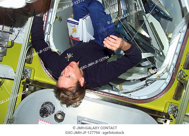Astronaut Michael L. Gernhardt, STS-104 mission specialist, floats in the Quest Airlock prior to getting suited for the second of three scheduled STS-104 space...