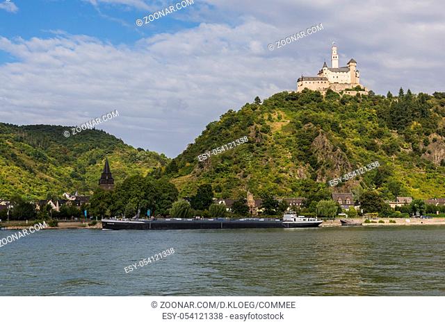 Marksburg, Germany - August 20, 2016: Marksburg Castle on a hill with the Rhine and ship in Braubach, Germany