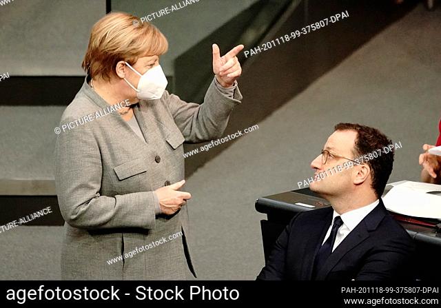 18 November 2020, Berlin: Chancellor Angela Merkel (CDU) talks to Jens Spahn (CDU), Federal Minister of Health, in the debate leading up to the adoption of the...