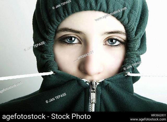 Germany, Cologne, Portrait of teenage girl wearing hooded top, close up