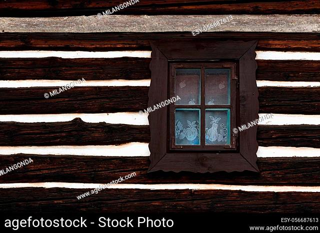 Window and a wall of a traditional wooden cottage in a village of Turiec Region in northern Slovakia