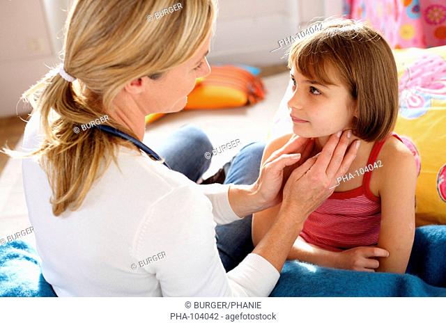 Doctor examining the lymph nodes of 7 years old girl